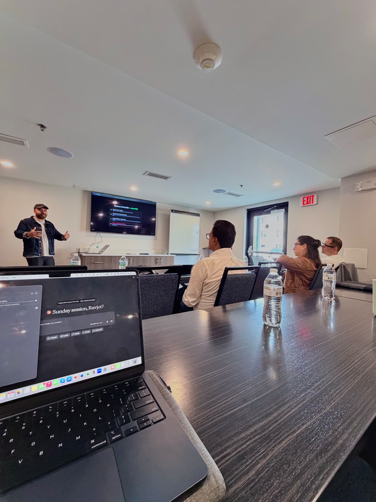 Speaking to workshop attendees with a screen behind