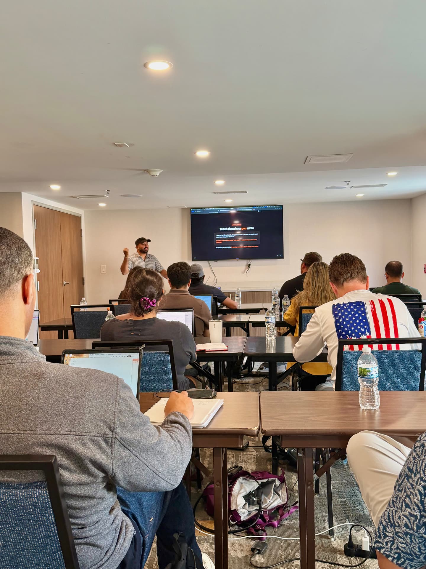 Scenes from past workshops: speaking to attendees and leading classroom sessions