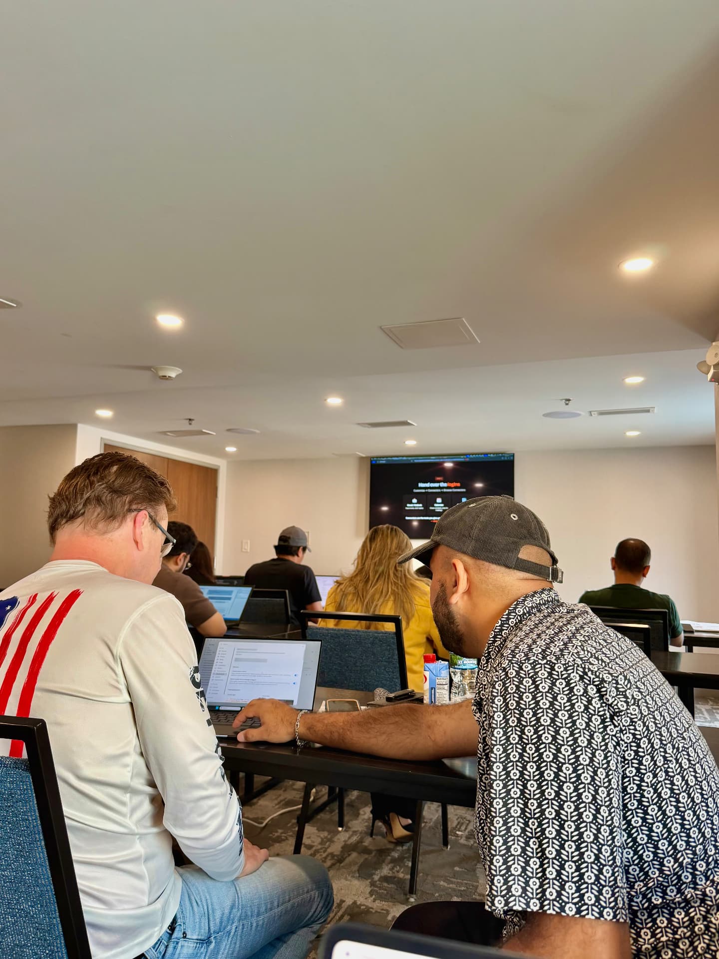 Workshop room watching a live AI demo on screen