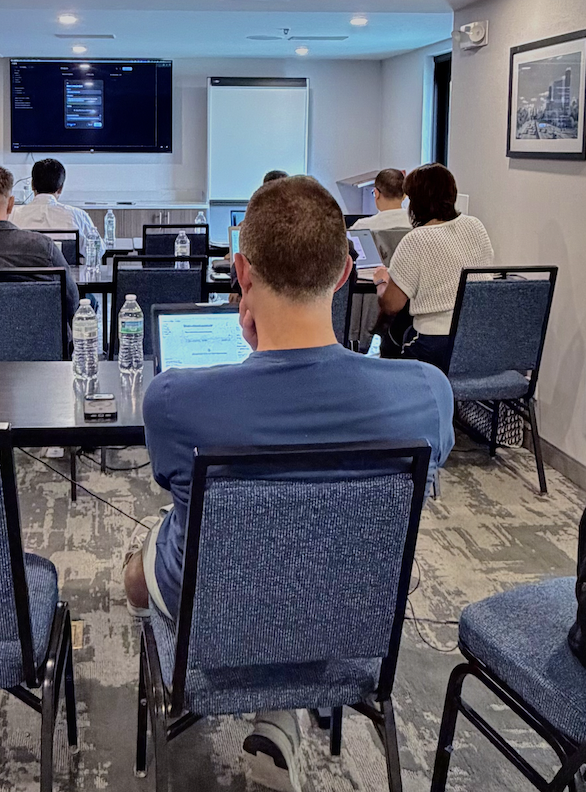 Attendees working on laptops during a workshop session